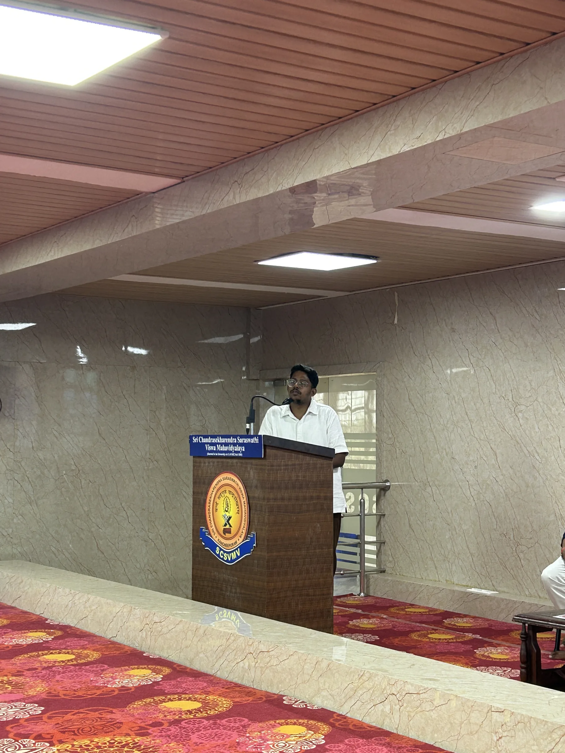 A student host speaking from the SCSVMV lectern during APEX