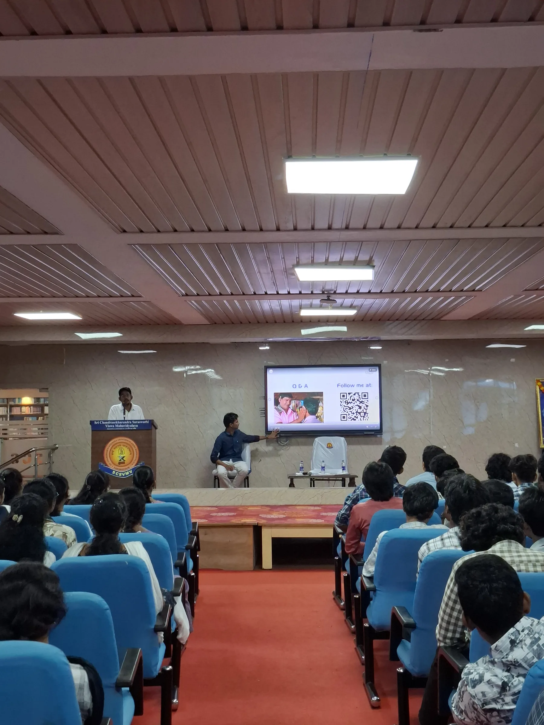 The APEX speaker answering questions in front of the audience